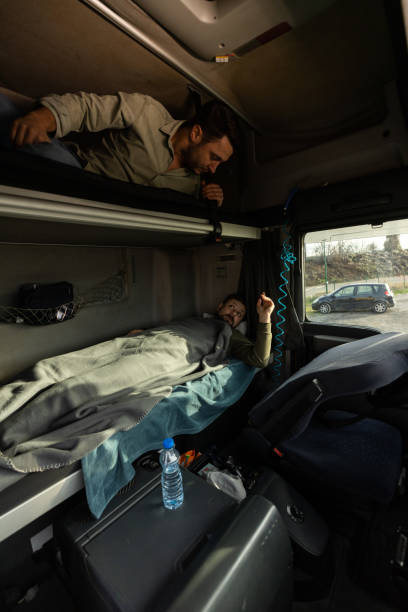 istock Two truck drivers taking a break and going to sleep 1358863060