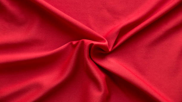 istock Red fabric cloth with folds background and texture. 1358866614