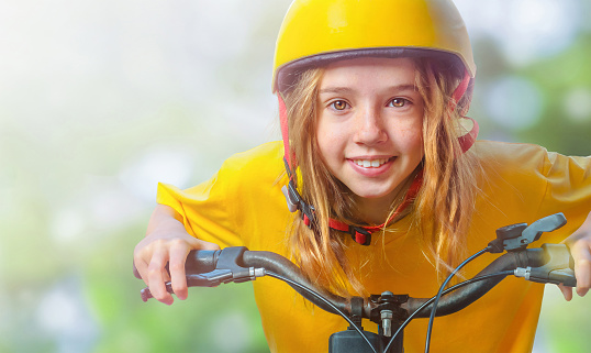 Portrait of the teenager in the helmet on the bicycle