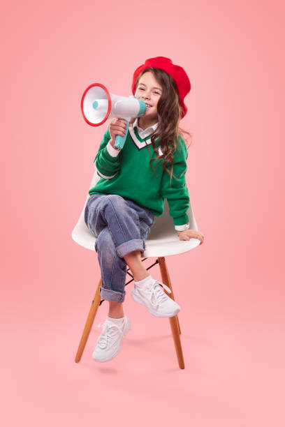 istock Little leader with loudspeaker sitting on chair 1358868188