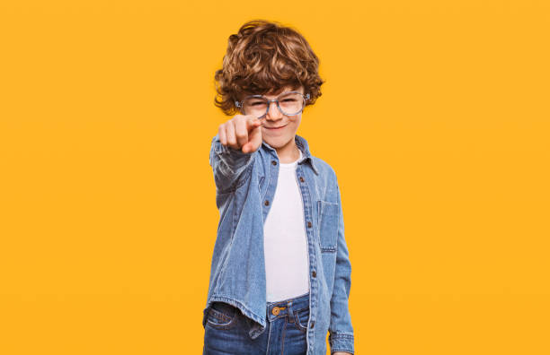 istock Stylish kid pointing with forefinger at camera 1358868203