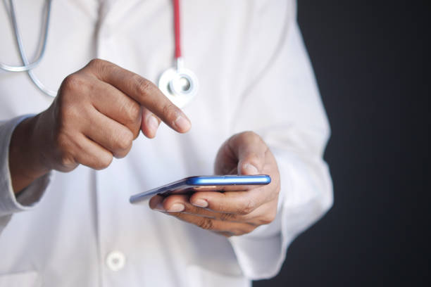 istock doctor in white coat using a smartphone. 1358874029