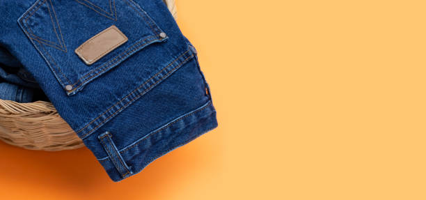 istock Blue jeans in laundry basket 1358874078
