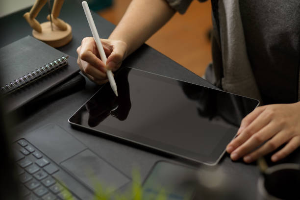 istock a female using stylus pen to draws on digital tablet 1358876011