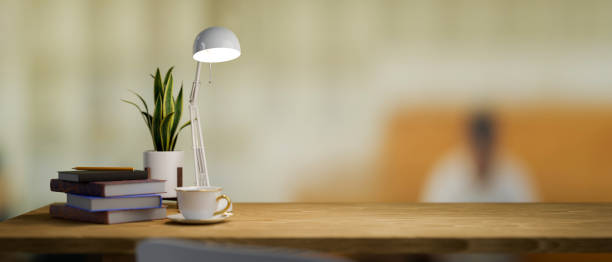 Simple wooden table with office supplies and copy space for product display over blurred office background. 3d rendering, 3d illustration