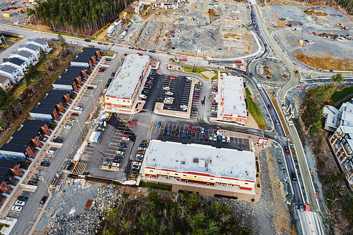 An aerial drone view of a road/roundabout/commercial construction site.