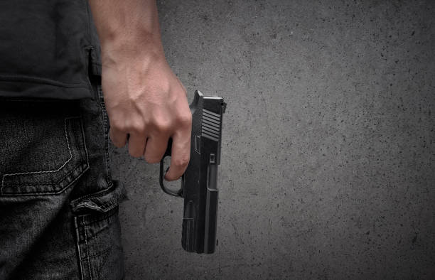 istock Killer with gun close up over grunge background with copyspace 1358881388