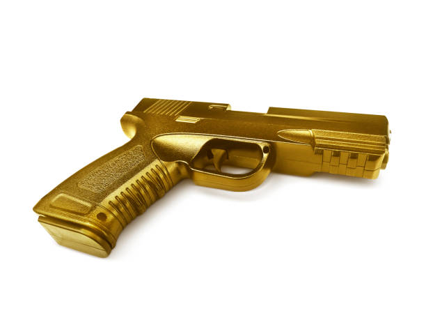 istock gun gold metal isolated on white background 1358881443
