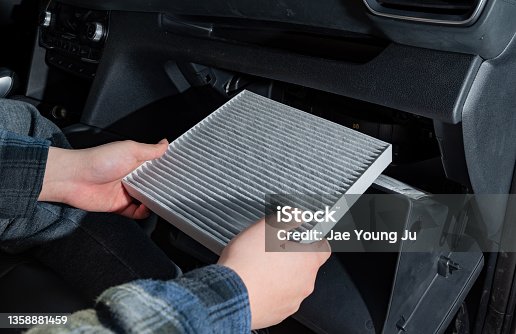 istock Changing the air filter inside the car. car maintenance. 1358881459