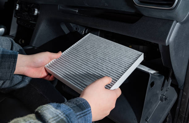 Changing the air filter inside the car. car maintenance. stock photo