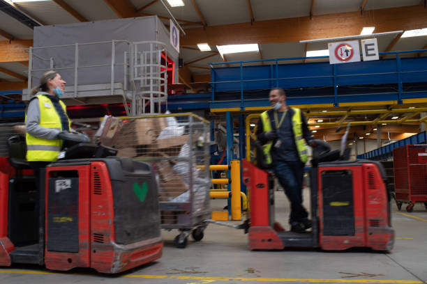 istock two electric tractor driver joke while working at industrial site 1358884139