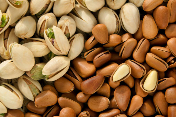 tasty pistachios and pine nut as background. - pine nut nut seed vegan food imagens e fotografias de stock