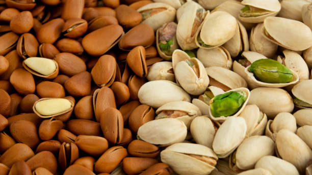 tasty pistachios and pine nut as background. - pine nut nut seed vegan food imagens e fotografias de stock