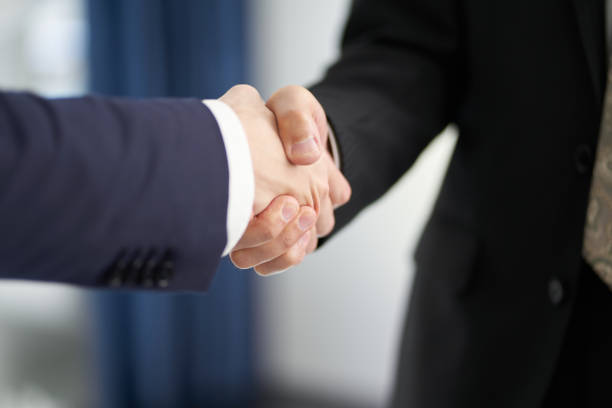 Asian business person shaking hands