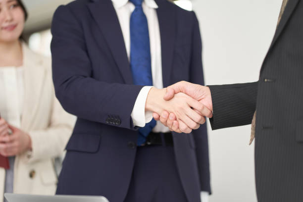 istock Asian business person shaking hands 1358885772