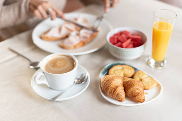 istock Coffee and croissant for breakfast served at a table. 1358891165