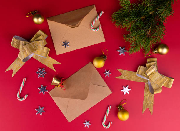 Christmas background. Envelopes and Christmas decorations on a red background.