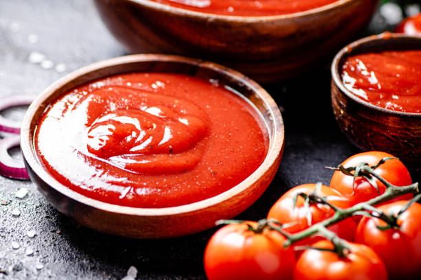 tomatensauce auf einem holzteller - ketchup stock-fotos und bilder
