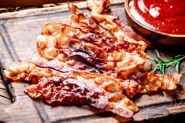 istock Pieces of fried bacon with tomato sauce 1358893897