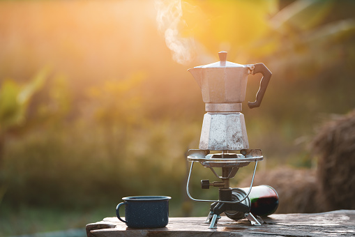 antique coffee pot On the gas stove for camping when the sun rises in the morning.soft focus.