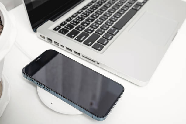 istock Charging smartphone battery with wireless charger device 1358894131