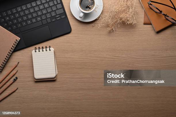 Stylish Workspace With Laptop Computer Notepad And Coffee Cup On Wooden Table Stock Photo - Download Image Now