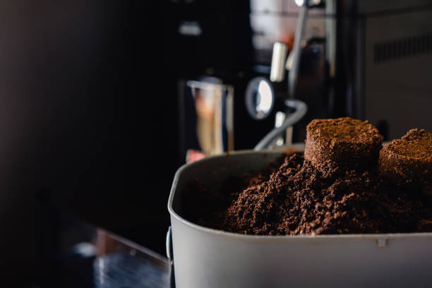 istock Used coffee grounds from espresso machine. Recycling compost container filled with used coffee waste. Coffee machine cleaning. 1358908782