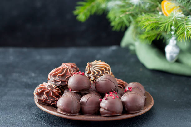 istock Marshmallow in chocolate on a clay plate on a dark background. 1358908799