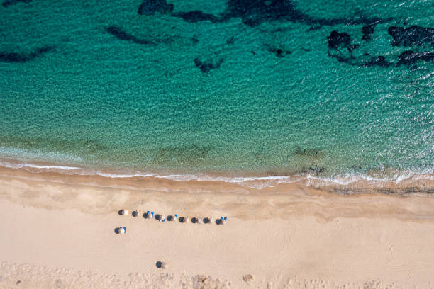 istock Drone top view of beach with umbrellas in Greece 1358909176