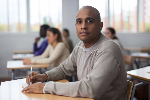 istock Focused man working at adult education class 1358913330