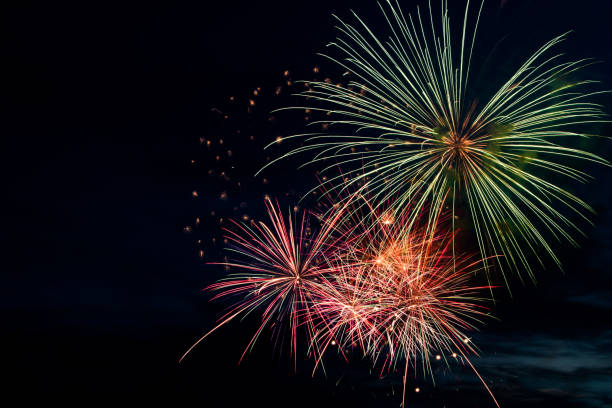 istock Colorful fireworks on black background. Celebration and holidays concept. Independence Day 4th of July, New Year, festival. Bright explosions of lights in sky. 1358914450