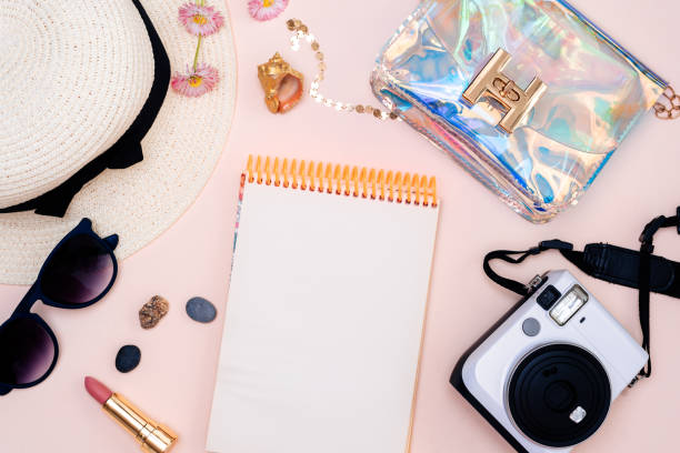 istock summer travel accessories. camera, hat, glasses and a flat Notepad top view lay flat on a light background 1358915054