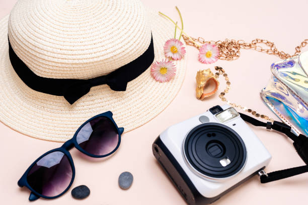 istock summer travel accessories. camera, hat, glasses and a flat Notepad top view lay flat on a light background 1358915069