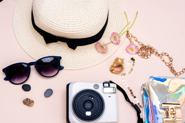 istock summer travel accessories. camera, hat, glasses and a flat Notepad top view lay flat on a light background 1358915073