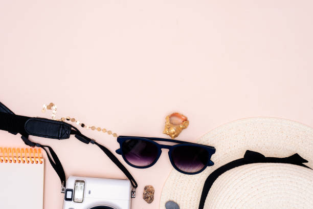 istock summer travel accessories. camera, hat, glasses and top view on a light background. with space for your text 1358915090