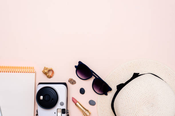 istock summer travel accessories. camera, hat, glasses and top view on a light background. with space for your text 1358915101