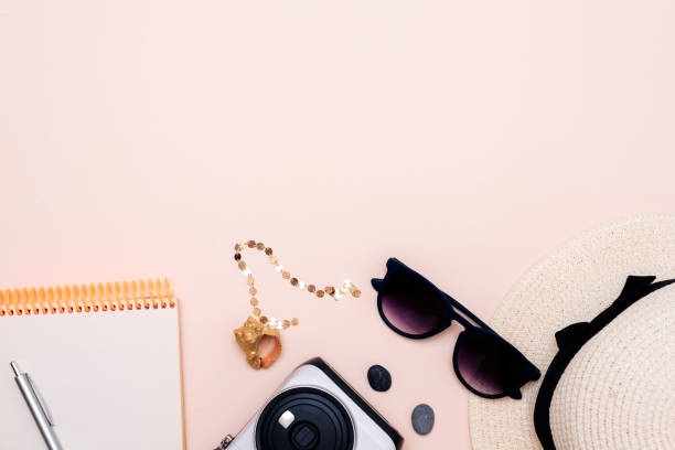 istock summer travel accessories. camera, hat, glasses and top view on a light background. with space for your text 1358915112