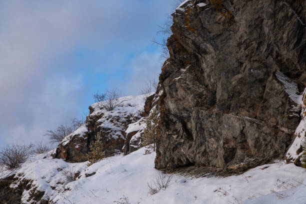 Powerful rocks covered with snow. Weather, climate.
