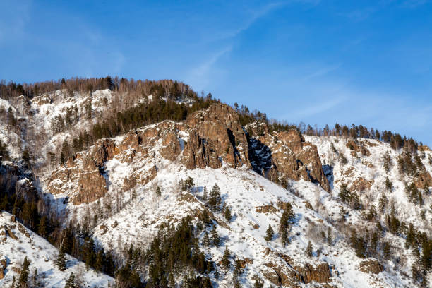 istock Mountains covered with forest and snow. Weather, climate. 1358915230
