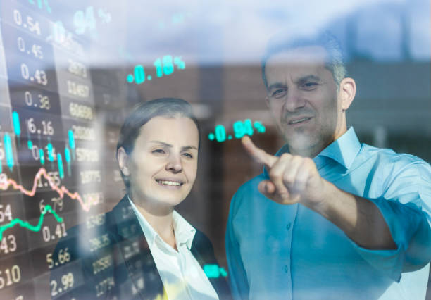 istock Busines couple watching stock market data on a modern interface 1358920407
