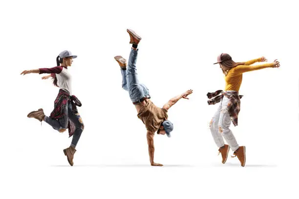 Photo of Two female dancers and one male dancer performing a hand stand
