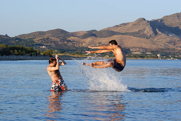 A young lady jumping into the water.