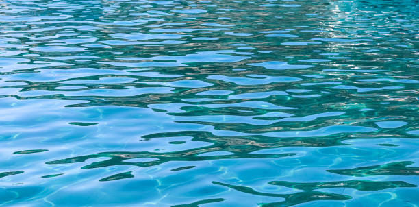 istock Turquoise sea in sunshine glow as surface background. Summer holidays concept 1358923124