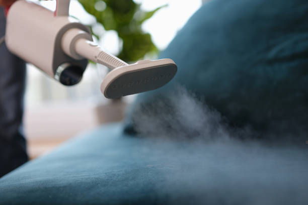 Steam comes out of the vacuum cleaner above the sofa Steam comes out of the washing vacuum cleaner above the sofa, close-up, blurry. Hygienic reading of upholstered furniture upholstered furniture stock pictures, royalty-free photos & images