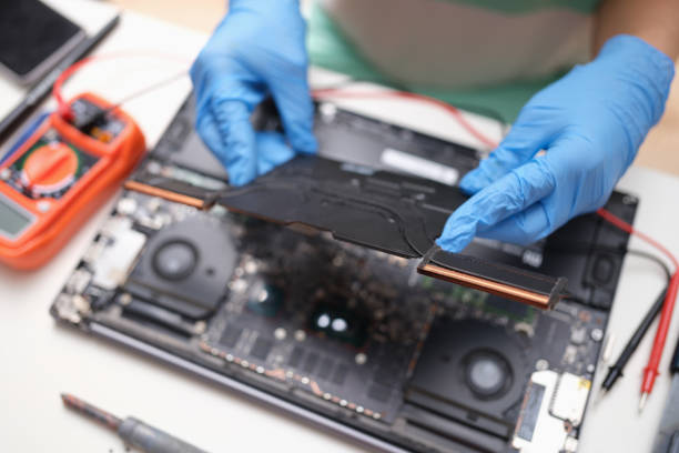 istock Gloved hands hold a laptop microcircuit, close-up 1358924745