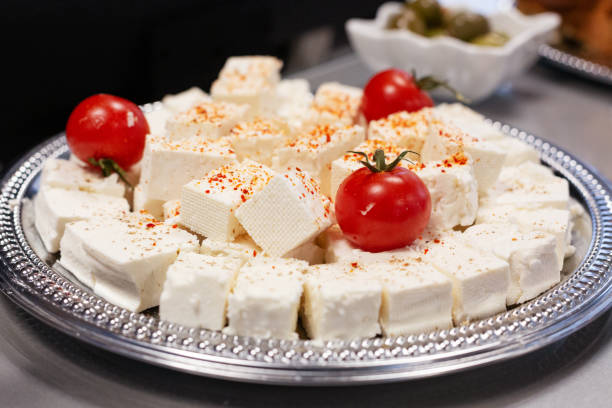 White cheese with cherry tomatoes on plate stock photo