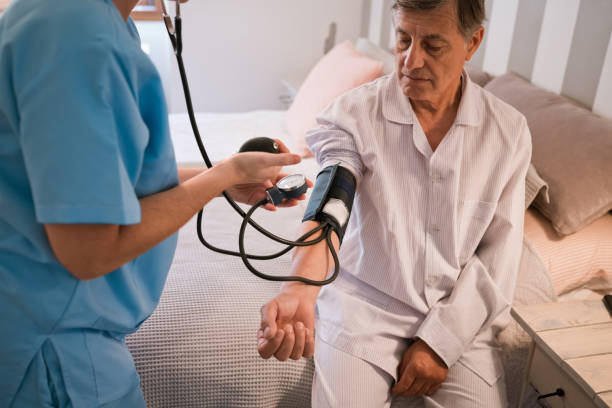 istock Nurse checking blood pressure 1358925841