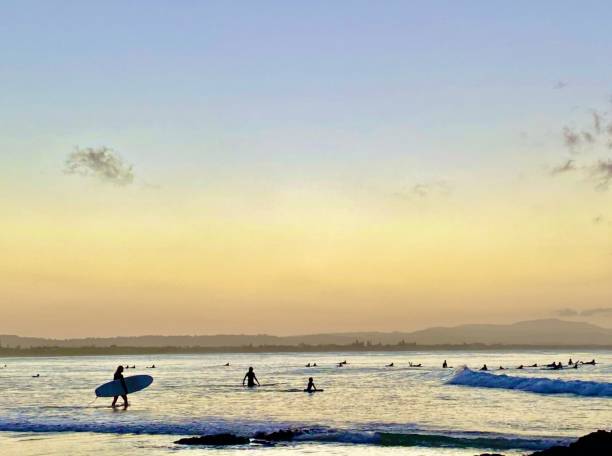 istock Silhouette of Ocean Surfer at Sunset 1358926026
