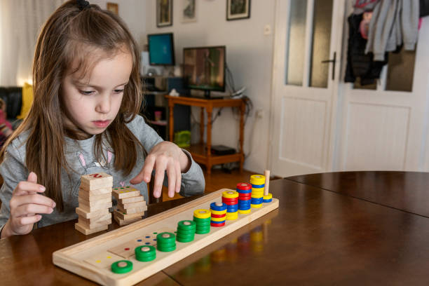 istock Child playing with mathematical toy 1358926055