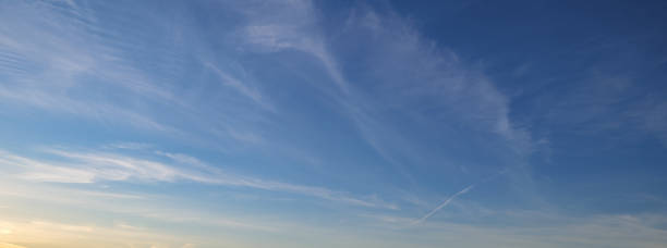 istock background with beautiful blue sky clouds and sun 1358926169